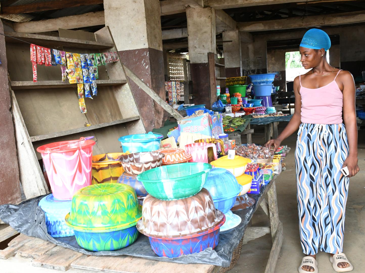 Woman in Market standing alongside her goods