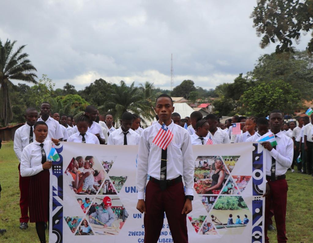 Young man standing in front of a banner