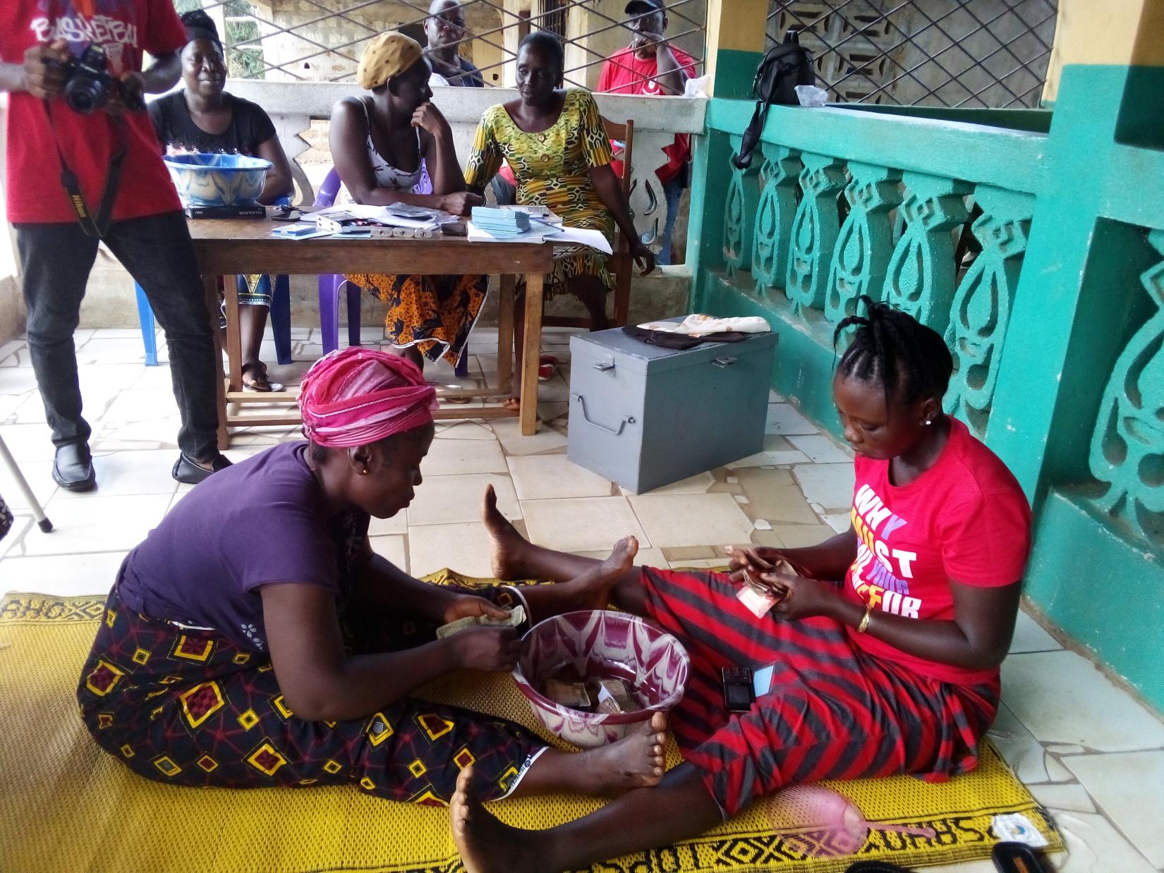 Village Savings Loan women checking cash