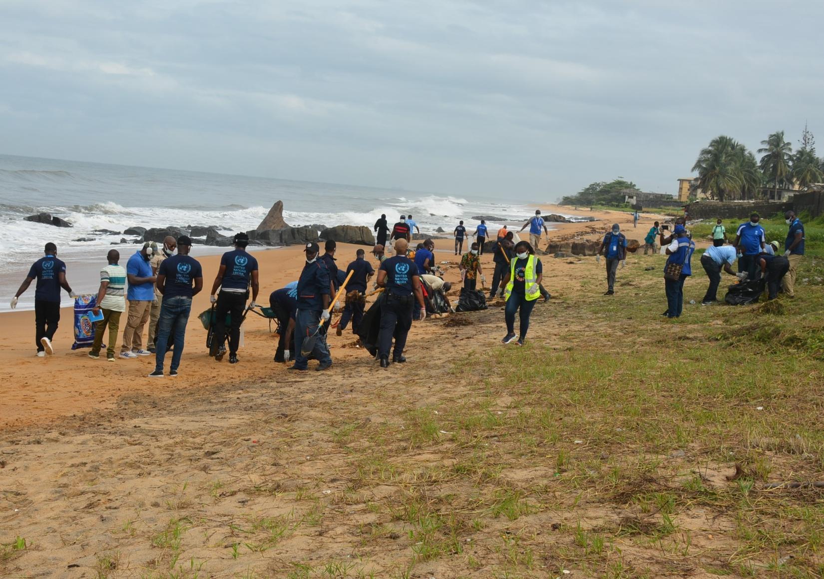 A group of people cleaning a beach