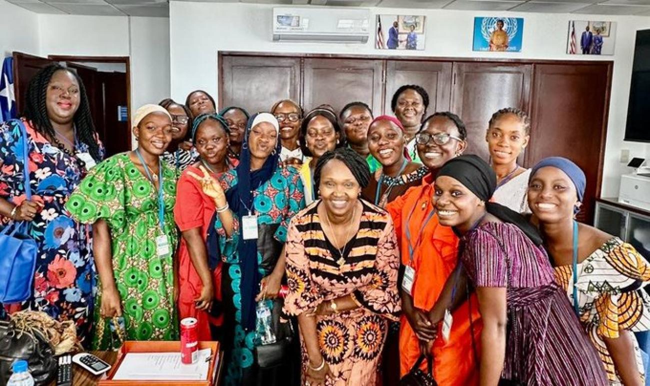 UN Resident Coordinator pose with a group of young ladies from Jewel Starfish Foundation