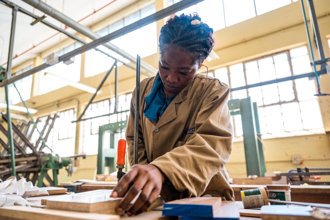 A young woman at TVET school practcing carpentry
