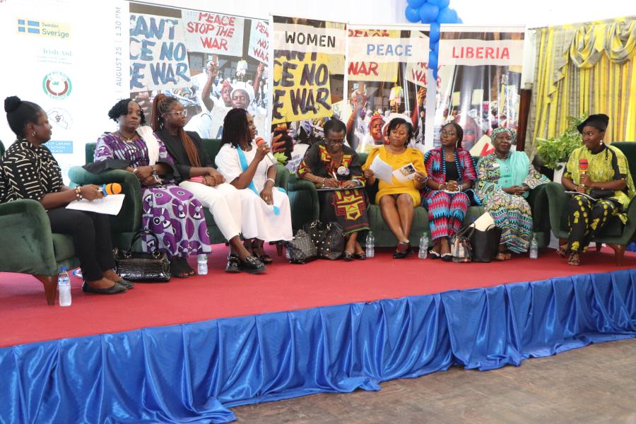 Women sitting together on the stage at the event 
