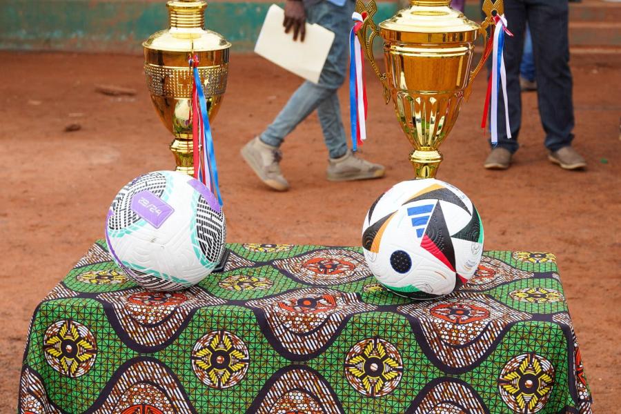 Two footballs on a table