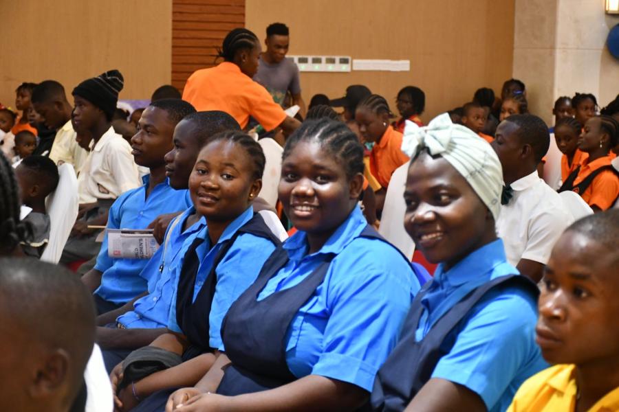 Students in blue uniform sitting