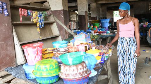 Woman in Market standing alongside her goods