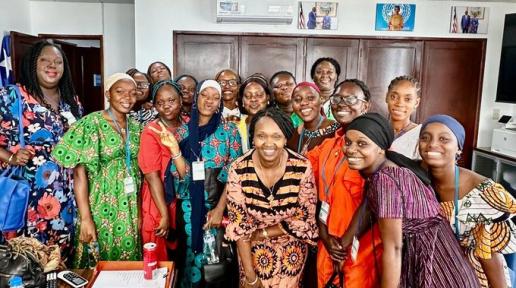 UN Resident Coordinator pose with a group of young ladies from Jewel Starfish Foundation