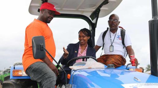 UN Resident Coordinator Christine Unumtoni ride in a tractor with beneficiaries