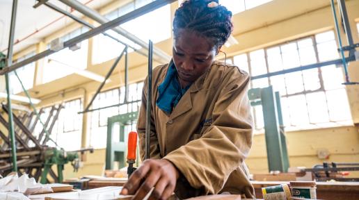 A young woman at TVET school practcing carpentry