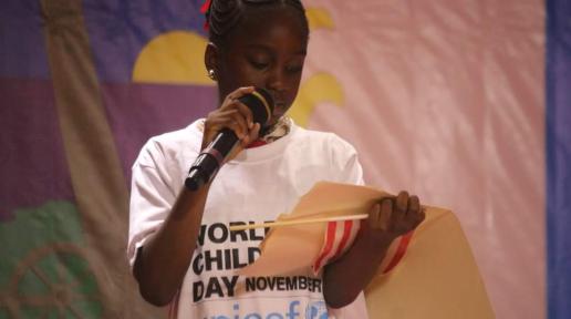 Girl wearing a white tshirt standing and holding a microphone